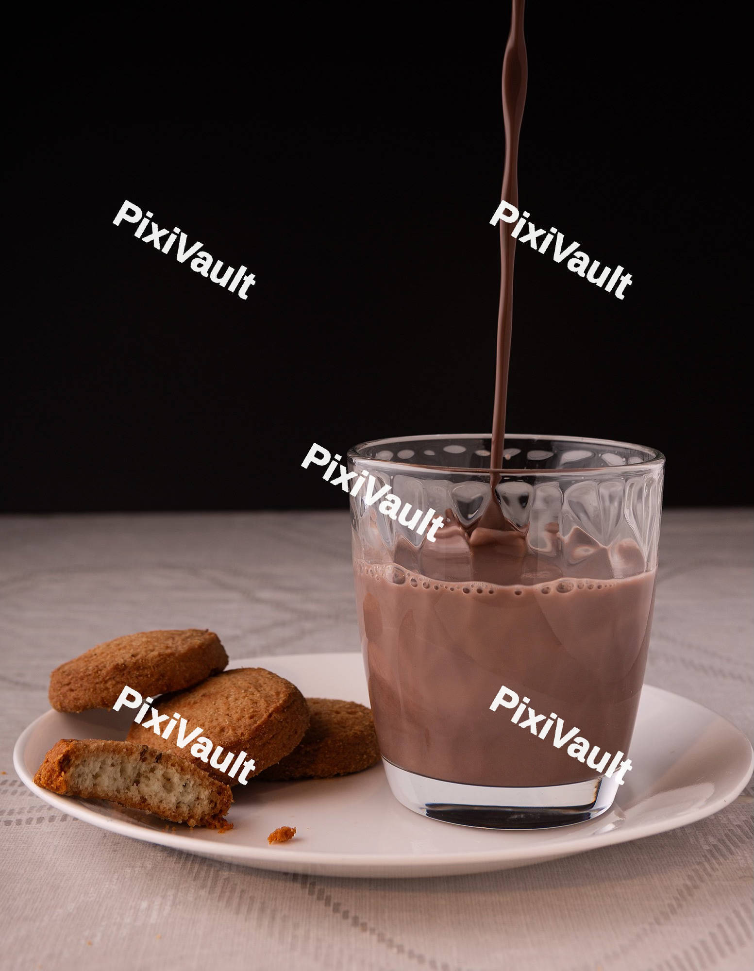 Chocolate milk falling on the glass
